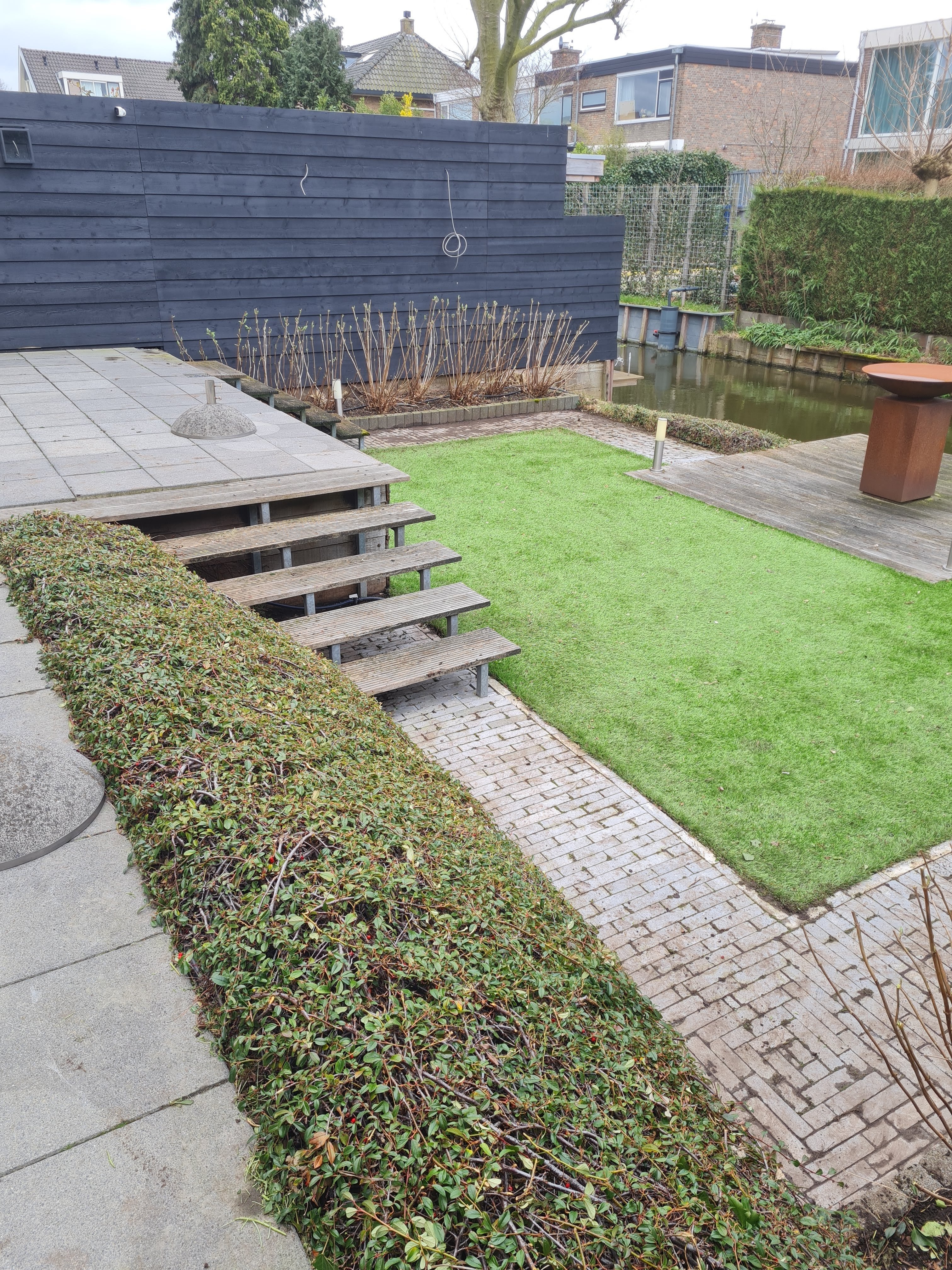 Stepping stone path through fresh green lawn, clean grass installation in modern garden